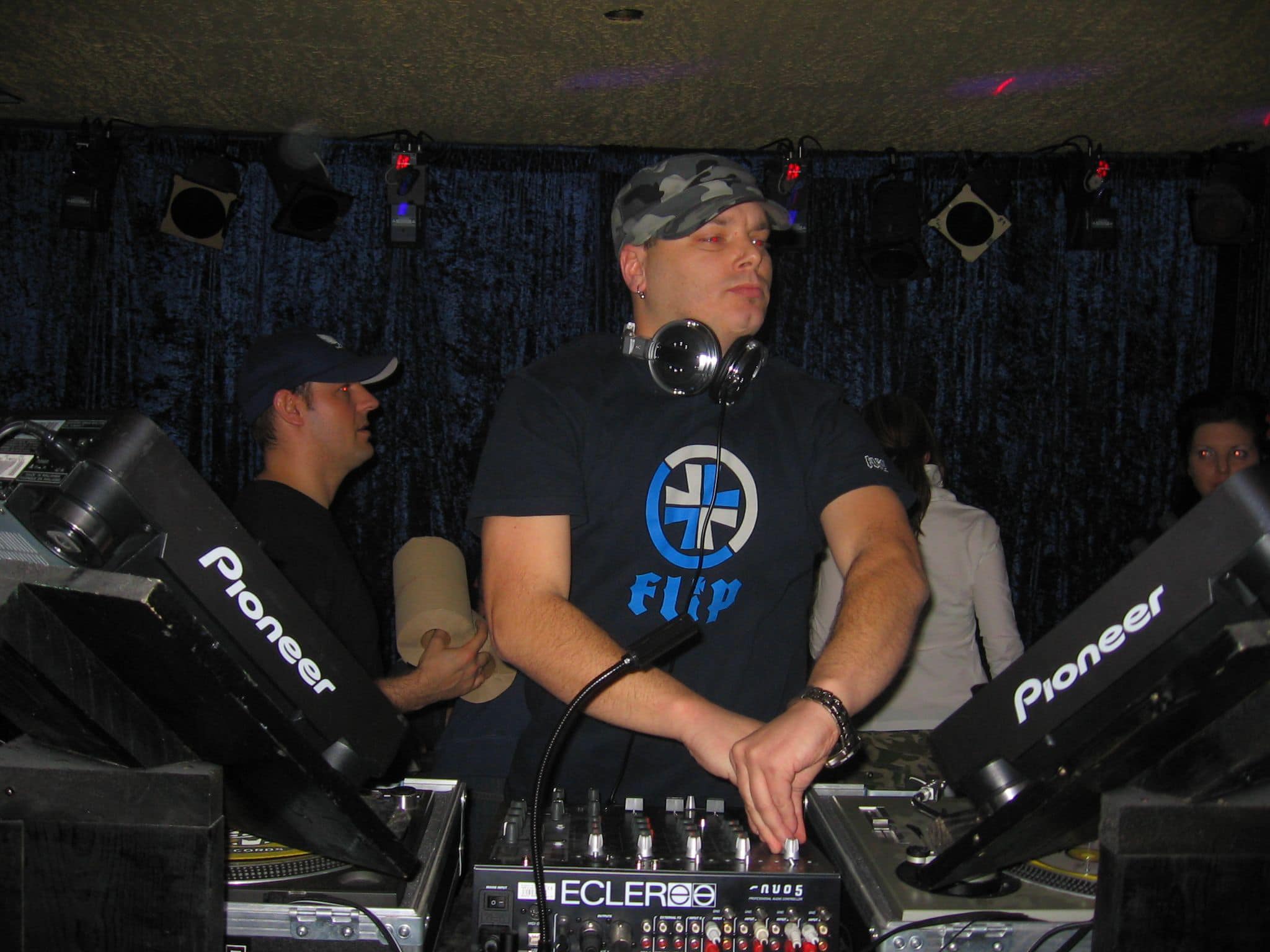 DJ Terry Bevvan at a club booth with Pioneer turntables
